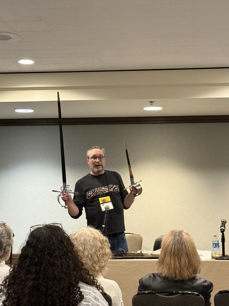 Dale holding a rapier and dagger