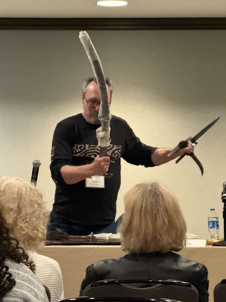 Dale holding three blades at once in Indian sword fighting style